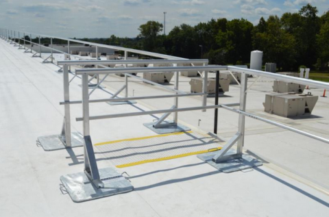 Safe access point to the fixed ladder along with safety rails along the edge of the upper roof.